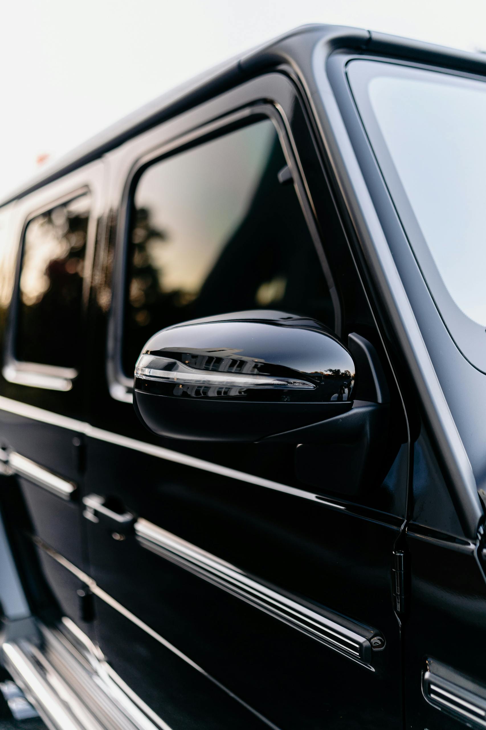 Elegant side view of a luxury black SUV highlighting its sleek design and sophistication.